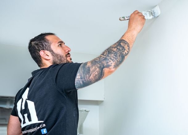 Painting the wall with a brush